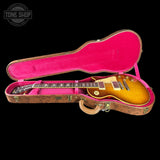 Gibson Les Paul guitar in a pink case with 'Tone Shop' logo.
