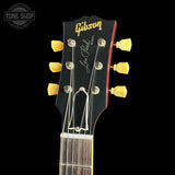 Gibson Les Paul guitar headstock with tuning pegs on a black background