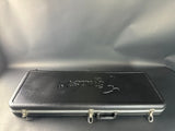 Black hard-shell case with a brand logo on a gray background