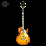 Electric guitar with a sunburst finish on a black background, featuring the Gibson logo.