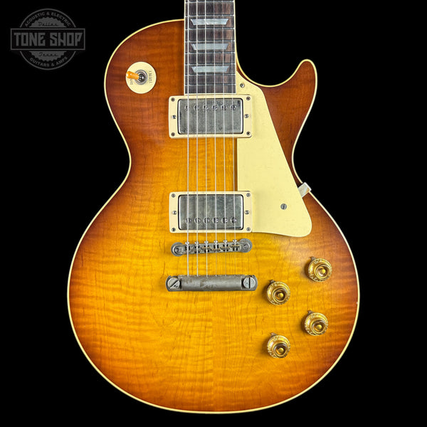 Electric guitar with a sunburst finish on a black background, featuring the Tone Shop logo.