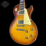 Electric guitar with a sunburst finish on a black background, featuring the Tone Shop logo.
