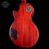 Red electric guitar body with 'Tone Shop' logo in the corner