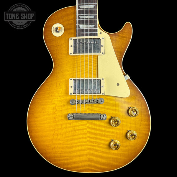 Electric guitar with a sunburst finish on a black background, featuring the Tone Shop logo.