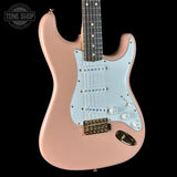 Pink electric guitar with a black background