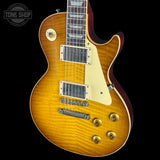 Electric guitar with a sunburst finish on a black background, featuring the Tone Shop logo.