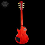 Red electric guitar on a black background with 'Tone Shop' logo.