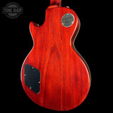 Red electric guitar body with Gibson logo on a black background