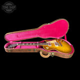 Gibson Les Paul guitar in a pink case with 'Tone Shop' logo.