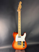 Electric guitar with a sunburst finish on a dark gray background