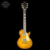 Electric guitar with a sunburst finish on a black background, featuring the Gibson logo.