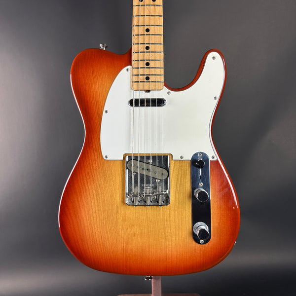 Electric guitar with a sunburst finish on a gray background