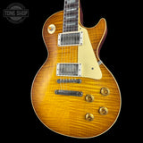 Electric guitar with a sunburst finish on a black background, featuring the Tone Shop logo.
