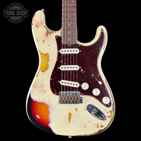 Worn electric guitar with visible wear and tear on a black background, featuring the Tone Shop logo.