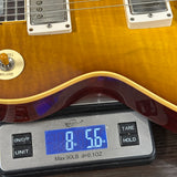 Guitar on a digital scale displaying weight