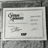 Certificate of Authenticity for an ESP guitar on a textured surface