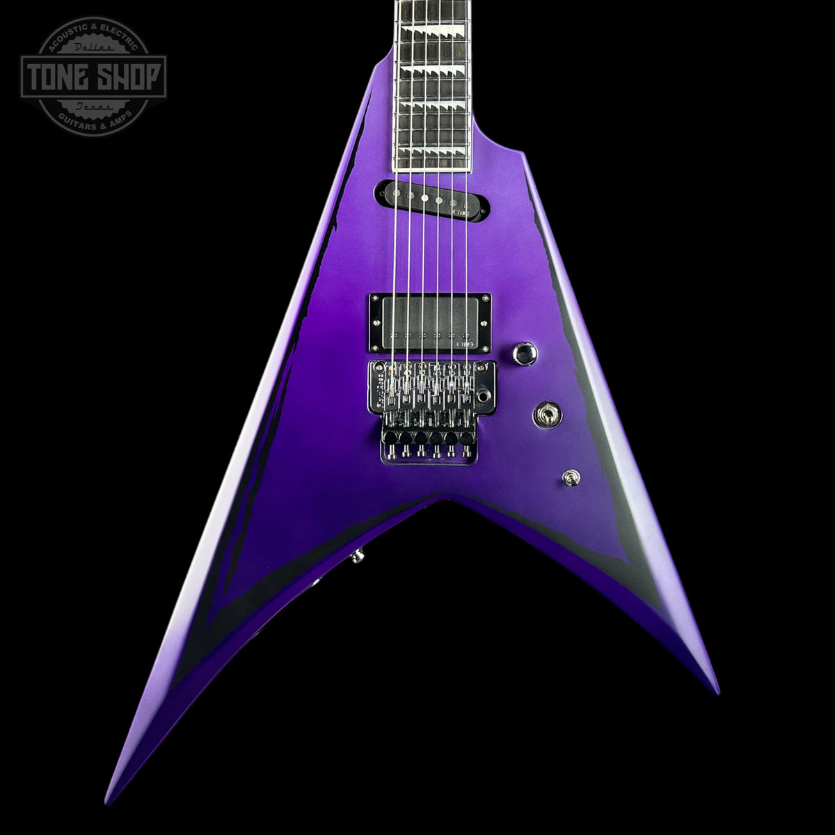 Purple electric guitar with a black background