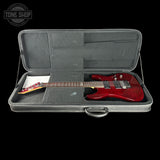 Red electric guitar in a gray case with 'Tone Shop' logo.