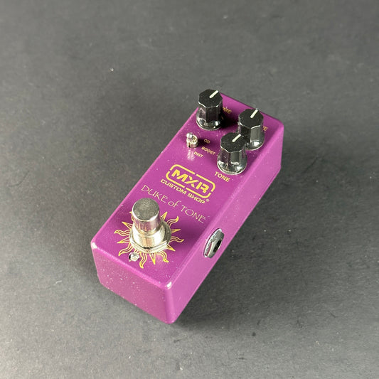 Purple guitar effects pedal with MXR branding on a gray background