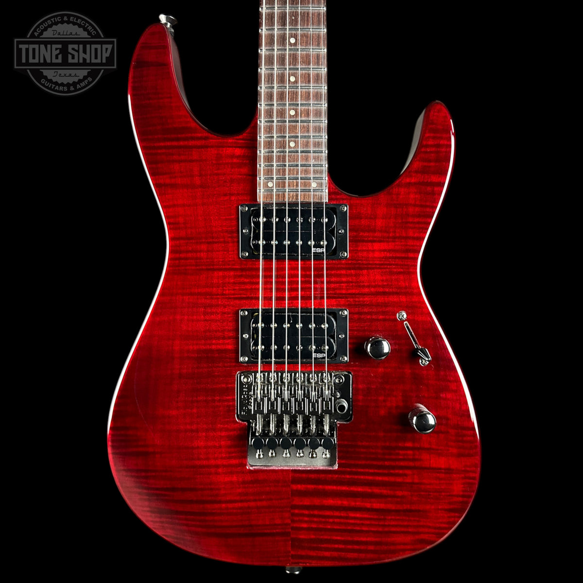 Red electric guitar with a black background