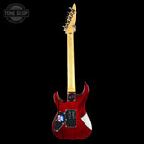 Red electric guitar with a black pickguard on a white background