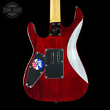 Red electric guitar with a white pickguard on a black background, featuring the Tone Shop logo.