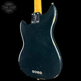 The back of a Fender electric guitar with a black body, showing the neck joint, hardware, and control knobs against a black background.