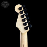 Guitar headstock with tuning pegs on a black background, featuring the Tone Shop logo.