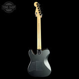 Electric guitar with a black finish on a white background, featuring the Tone Shop logo.