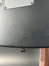 Close-up of a metallic surface with a scratch and a screw.