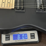Guitar on a digital scale displaying weight