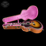 Guitar in a pink case with 'Tone Shop' logo in the corner
