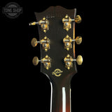 Gibson guitar headstock with tuning pegs on a black background