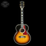 Acoustic guitar with a sunburst finish on a black background, featuring the Gibson logo.