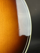 Close-up of a guitar's soundhole with a clear cover