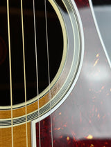 Close-up of an acoustic guitar's soundhole and strings