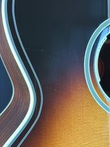 Close-up of a guitar's wooden body with a focus on the grain and finish.