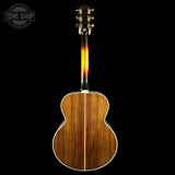 Acoustic guitar with a tortoiseshell neck on a black background, featuring the Tone Shop logo.