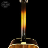 Close-up of a guitar's back and neck with 'Tone Shop' logo.