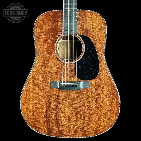 Acoustic guitar with a visible brand logo in the corner