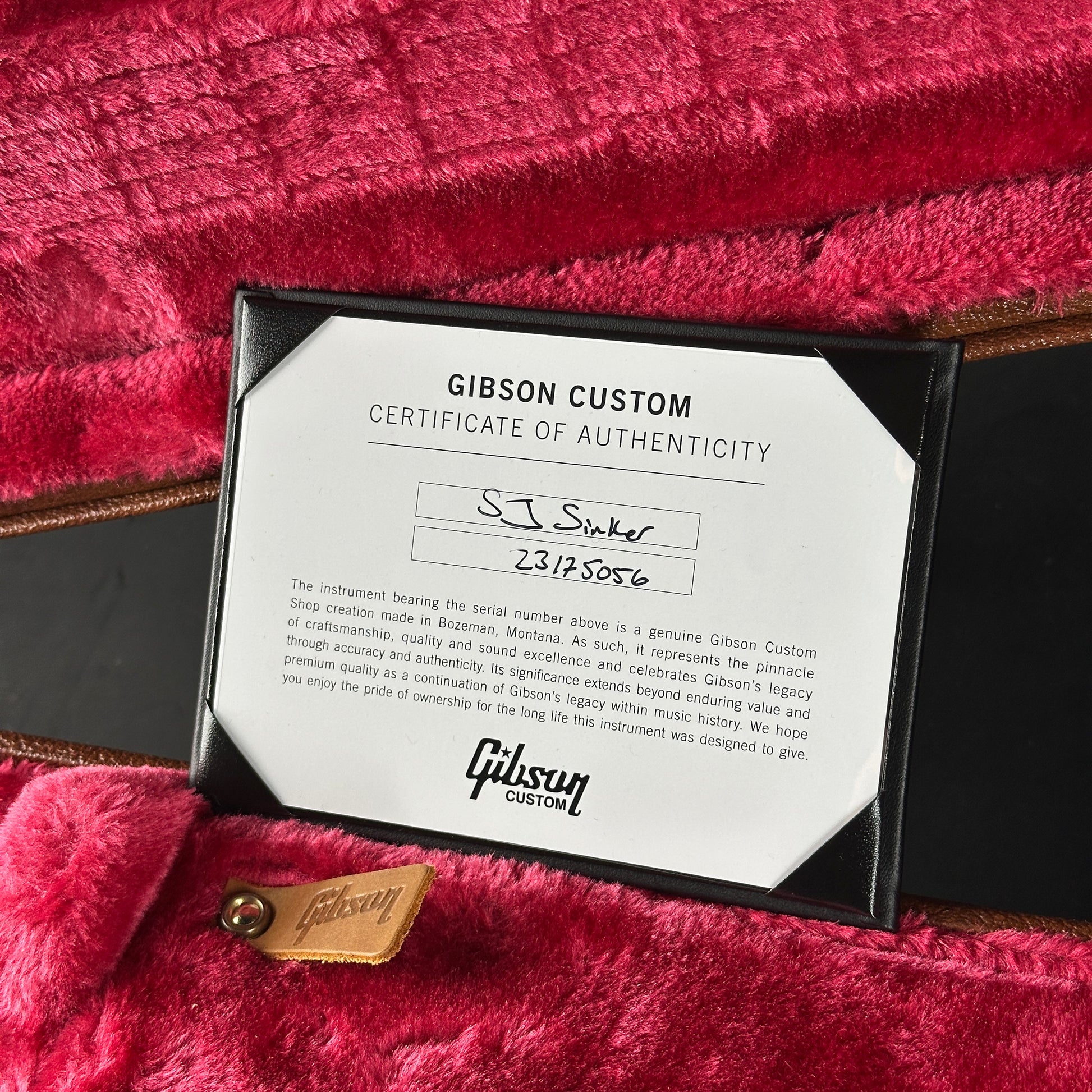 Gibson Custom Certificate of Authenticity on a red guitar case