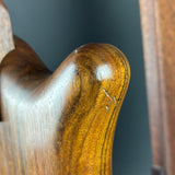 Close-up of a wooden handle with a dark gray background