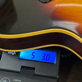 Used 1965 Gibson ES-125T Sunburst on scale displaying weight.