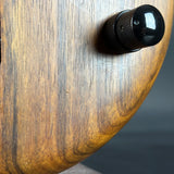 Black knob on a wooden surface