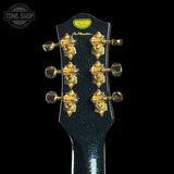 Guitar headstock with gold tuning pegs on a black background, featuring the Tone Shop logo.