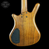 Wooden guitar body with a visible brand logo on a black background