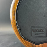Close-up of a Warwick guitar headstock with wooden finish