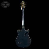 Black electric guitar headstock on a white background with 'Tone Shop' logo.