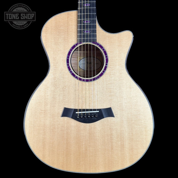 Acoustic guitar with a visible brand logo on a black background