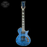 Blue electric guitar on a black background with 'Tone Shop' logo.